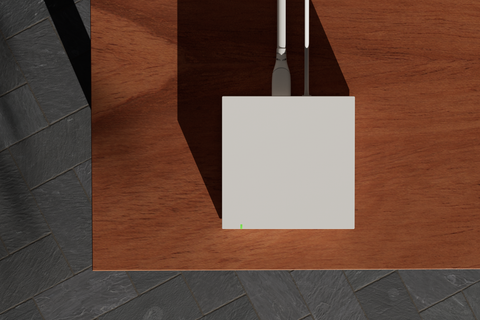 Square white Insteon hub on a wooden surface